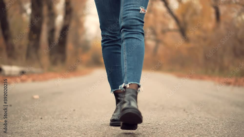 Woman Legs Walking On Fallen Leaves Woman Legs Walking On Fallen Leaves