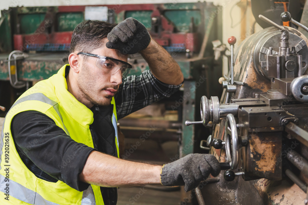 The worker producing the manufacturing metal parts The worker producing the manufacturing metal parts