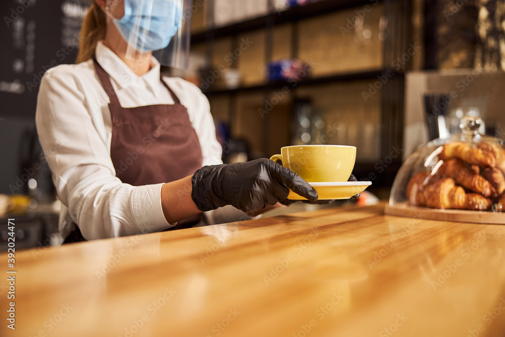 Wooden surface of the bar counter and barista working at it Wooden surface of the bar counter and barista working at it