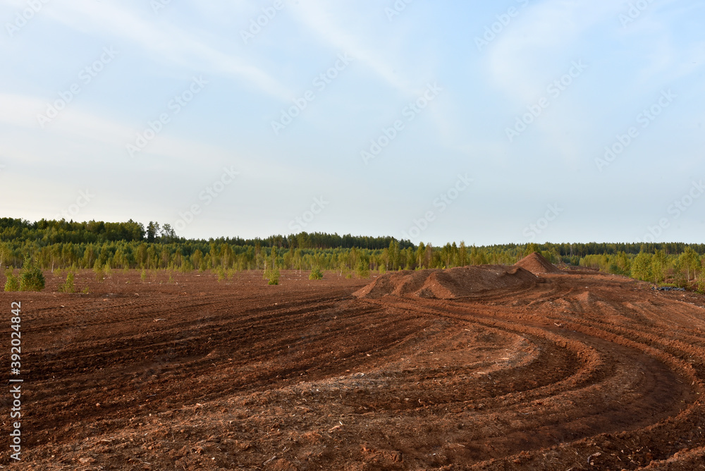 Landscape on peatlands where being development of the peat. Drainage of peat bogs at extraction site. Drilling on bog for oil exploration. Wetlands declining and under threat.