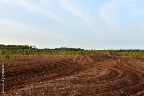 Landscape on peatlands where being development of the peat. Drainage of peat bogs at extraction site. Drilling on bog for oil exploration. Wetlands declining and under threat.