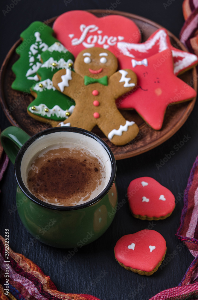 On a black background: a bowl of gingerbread and a mug of cocoa.
