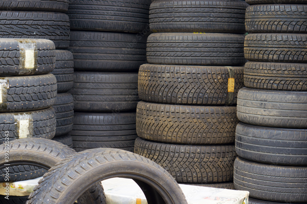 A large number of tires prepared for replacement at a car service station. A large number of tires prepared for replacement at a car service station.