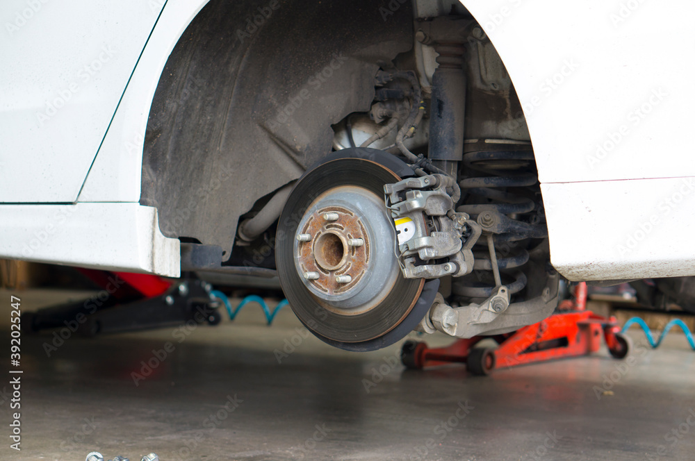 Car brake disc when changing wheels at a car service station.