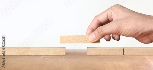 Hand arranging wood block . Business concept growth success