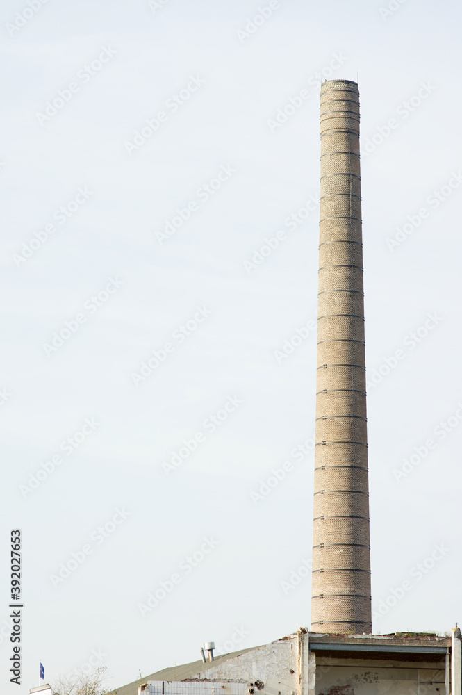 Old dilapidated factory chimney in the center of Arnhem, Netherlands