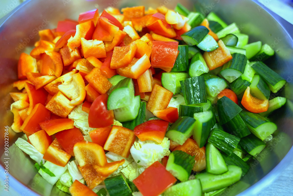 Coarsely chopped fresh vegetable salad in a large plate. Top view Coarsely chopped fresh vegetable salad in a large plate. Top view
