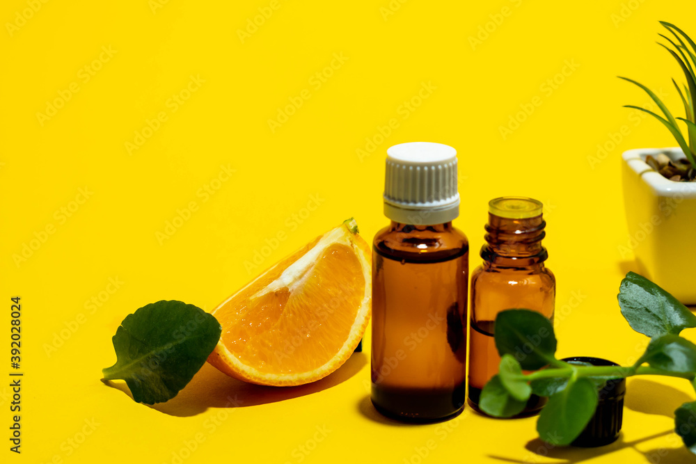 Orange Essential oils , various bottles aromatherapy on a yellow background. Aromatherapy and perfumes concept. Place for text. Citrus arometherapy oils. Orange Essential oils , various bottles aromatherapy on a yellow background. Aromatherapy and perfumes concept. Place for text. Citrus arometherapy oils.