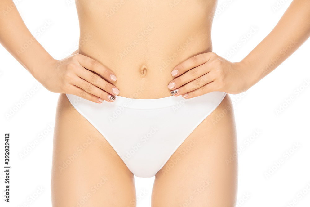 Belly. Close up beautiful female model on white background. Beauty, cosmetics, spa, depilation, diet and treatment, fitness concept. Fit and sportive, sensual body with well-kept skin in underwear.