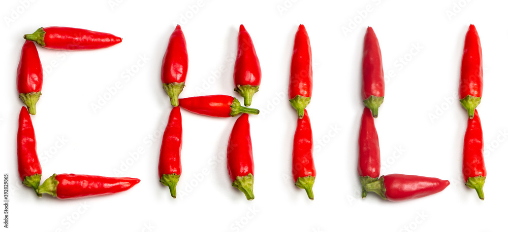 Word chili made up of fresh red peppers on white background Word chili made up of fresh red peppers on white background