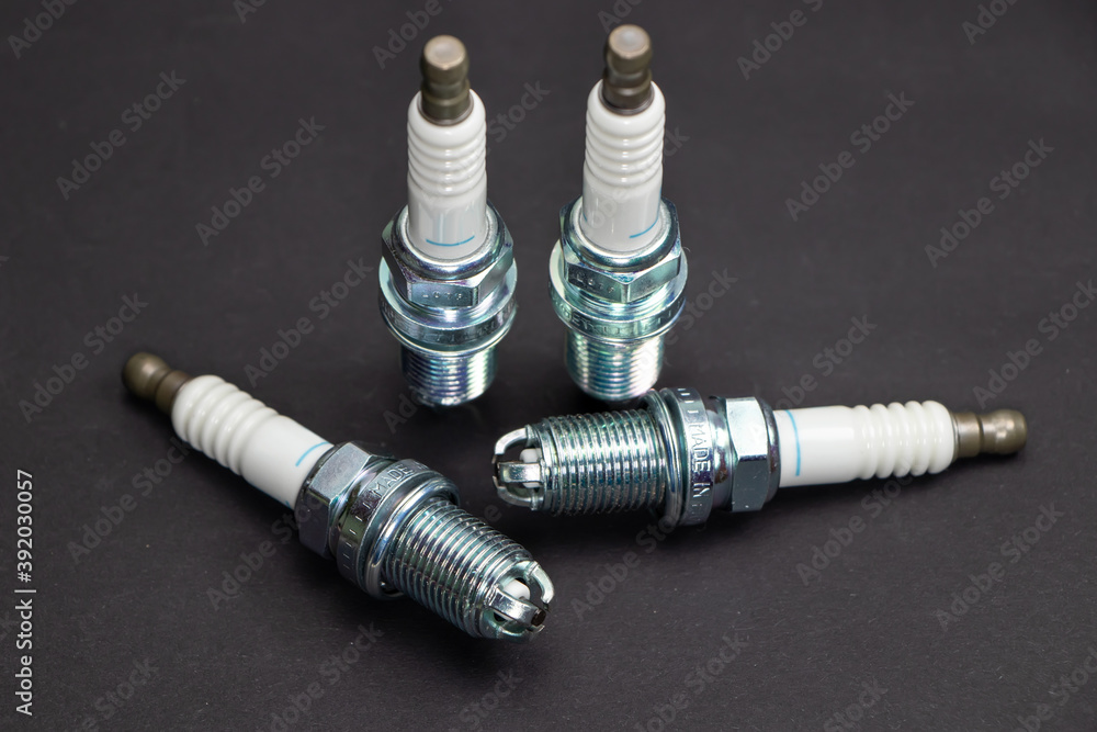 Spark plugs on black background. Car and motorcycle part Spark plugs on black background. Car and motorcycle part
