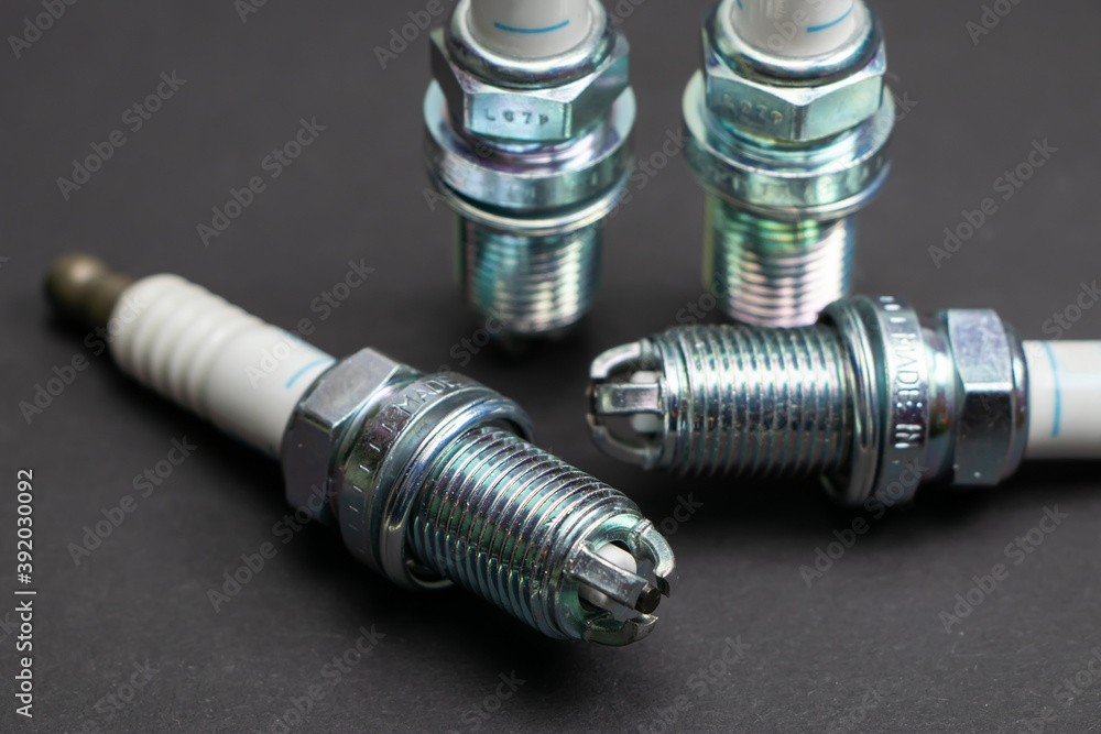 Spark plugs on black background. Car and motorcycle part Spark plugs on black background. Car and motorcycle part
