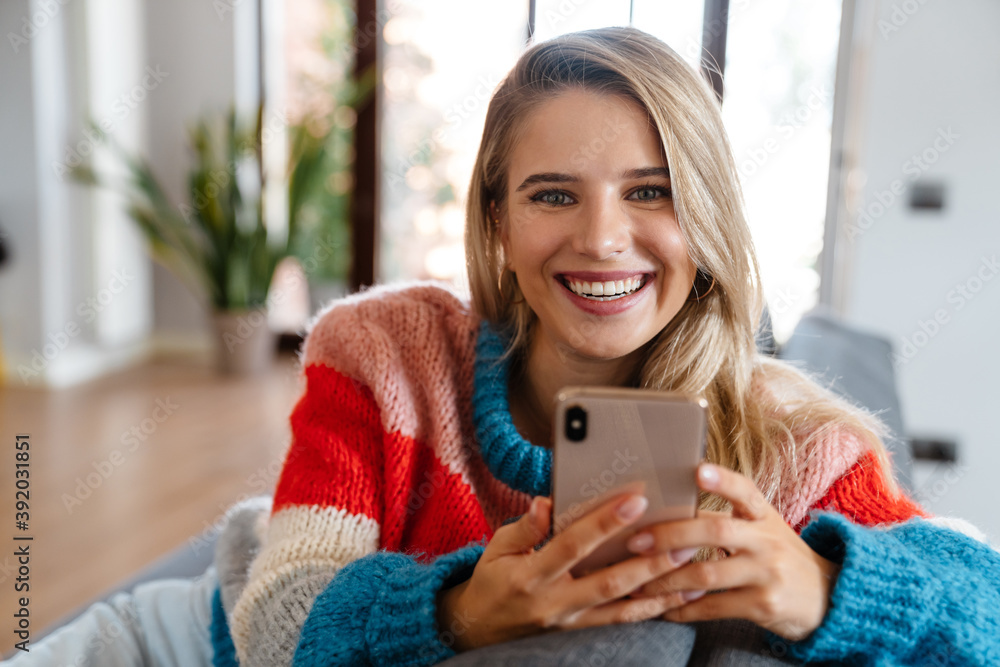 Attractive smiling young woman using mobile phone Attractive smiling young woman using mobile phone