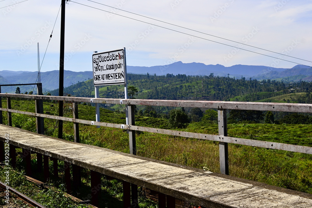 Great Western railway hill station on the mountain railroad in Sri Lanka. Old wrathered platform on a background of hills woth tea plantations.