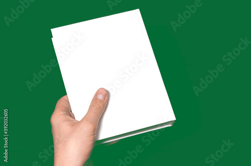 A mock-up of a white closed book with a place for text in a hand