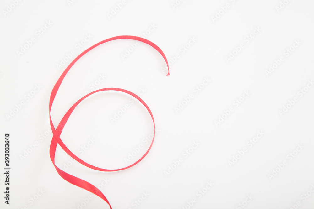 Curved red wavy ribbon on white in shape of number 6 with space Curved red wavy ribbon on white in shape of number 6 with space