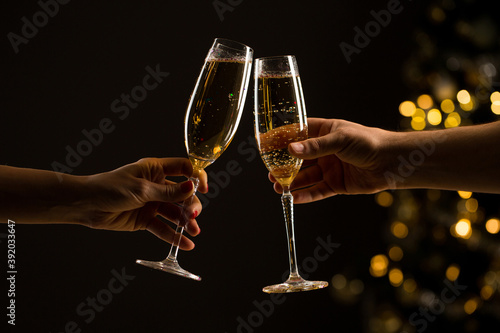 New Year concept, woman and man with champagne glasses clinking