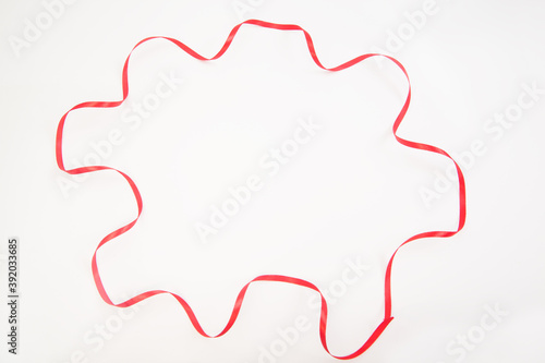 red wavy ribbon in multiangle shape on white with copy space photo
