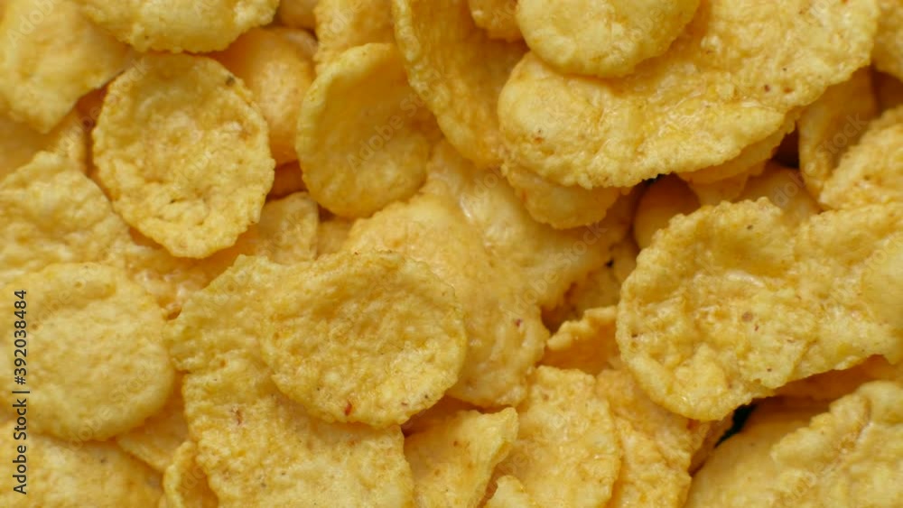 Rotating corn chips closeup, macro view food background Rotating corn chips closeup, macro view food background