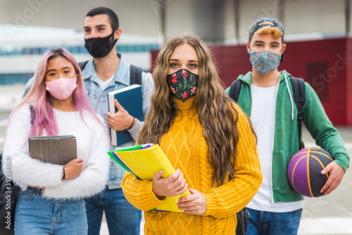 Group of young students bonding outdoors