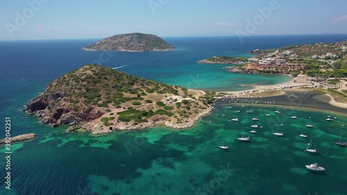 Aerial drone video of famous small islet with picturesque chapel of Agios Nikolaos and small marina, Anavissos area, Attica, Greece photo