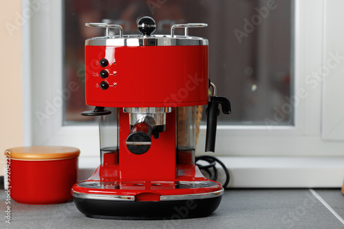 Fototapeta Naklejka Na Ścianę i Meble -  Red domestic coffee machine on kitchen counter