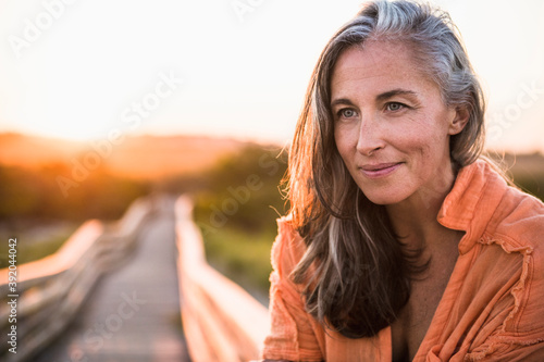 Portrait of Gray Haired Woman at the beach for sunset