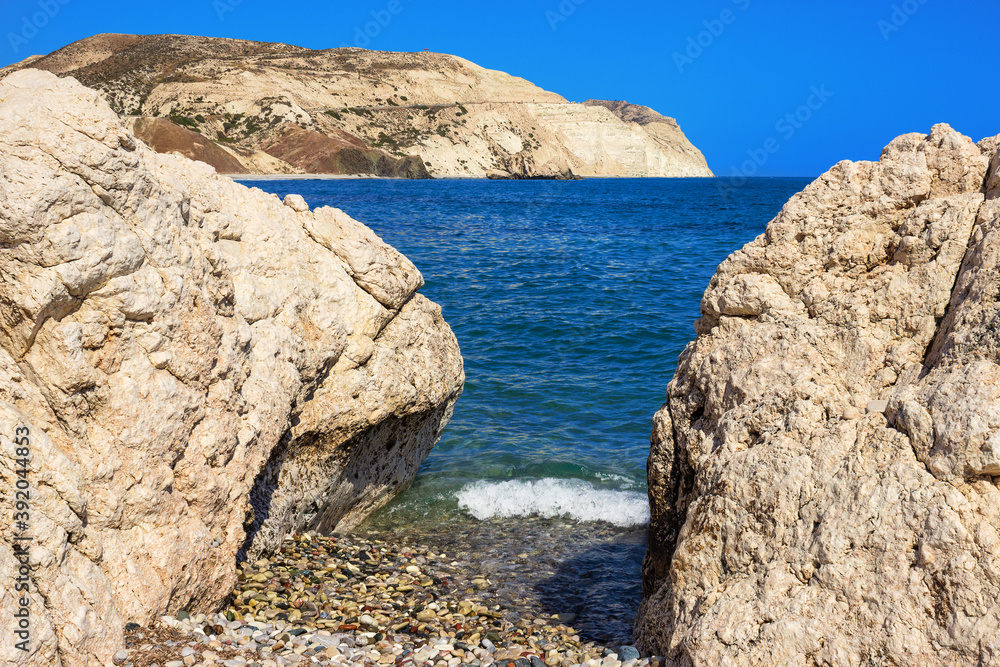 secluded place on the Cyprus beach with blue water and rocks