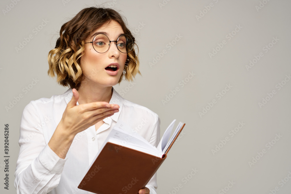 woman with notepad in hands business work beige background glasses hairstyle woman with notepad in hands business work beige background glasses hairstyle