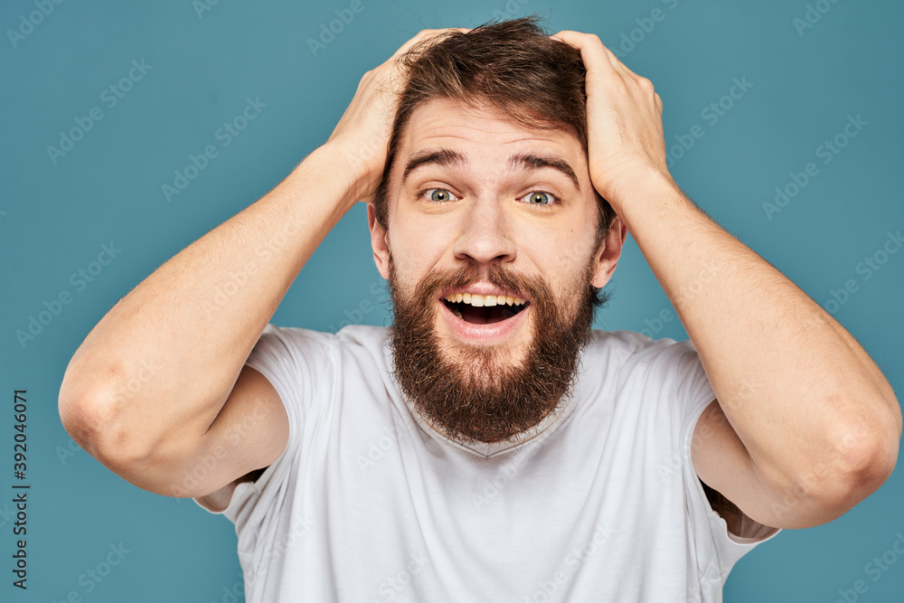 emotional man gesturing with hands lifestyle fun white t-shirt blue isolated stock emotional man gesturing with hands lifestyle fun white t-shirt blue isolated stock
