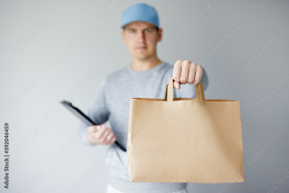 delivery man giving fast food order over white background delivery man giving fast food order over white background