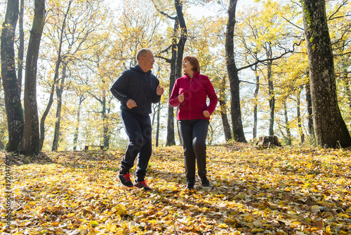 Seniors jogging on a forest