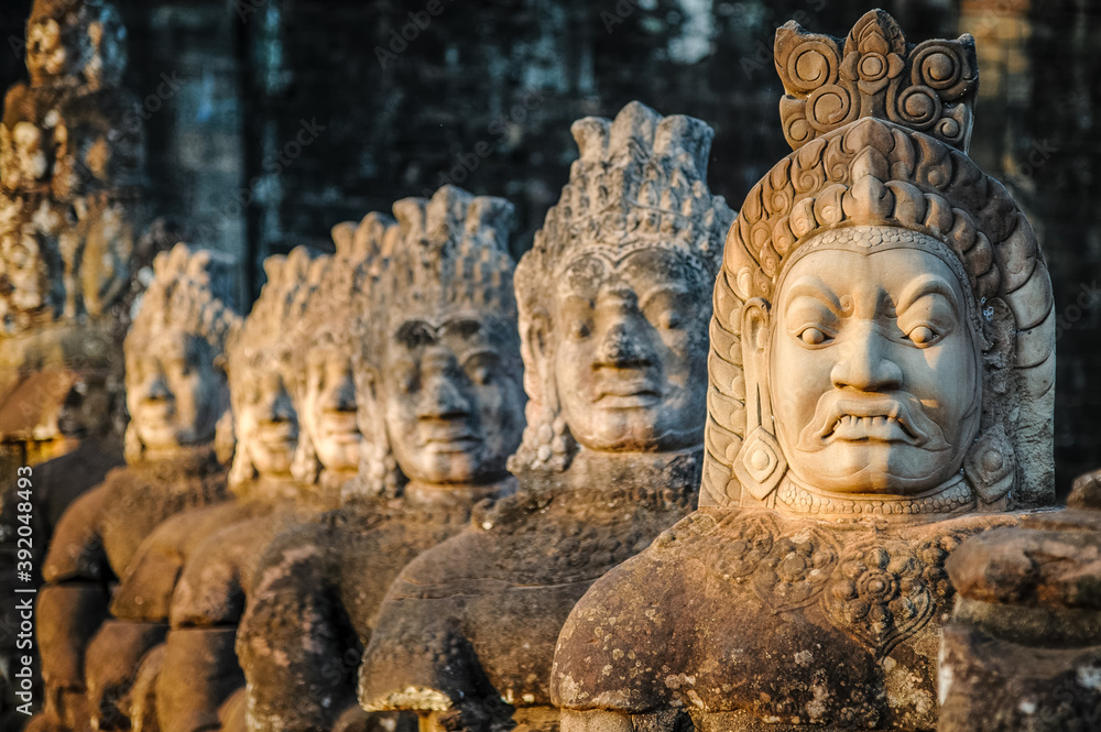 Angkor Archaeological Park, Siem Reap, Cambodia. Close up of ancient carved faces on south gate of Angkor Thom. Angkor Archaeological Park, Siem Reap, Cambodia. Close up of ancient carved faces on south gate of Angkor Thom.