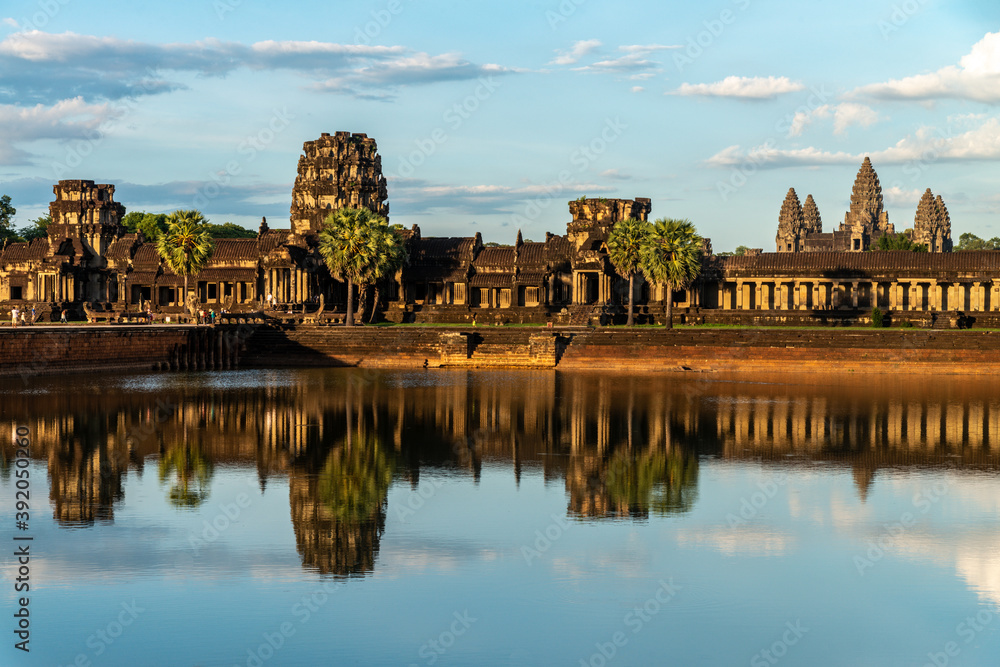 Angkor Archaeological Park, Siem Reap, Cambodia. Main entrance of Angkor Wat against cloudy blue sky in late afternoon light from west side. Angkor Archaeological Park, Siem Reap, Cambodia. Main entrance of Angkor Wat against cloudy blue sky in late afternoon light from west side.