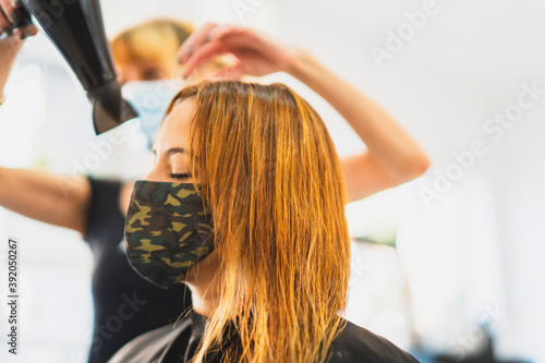 woman in salon receiving hair treatment