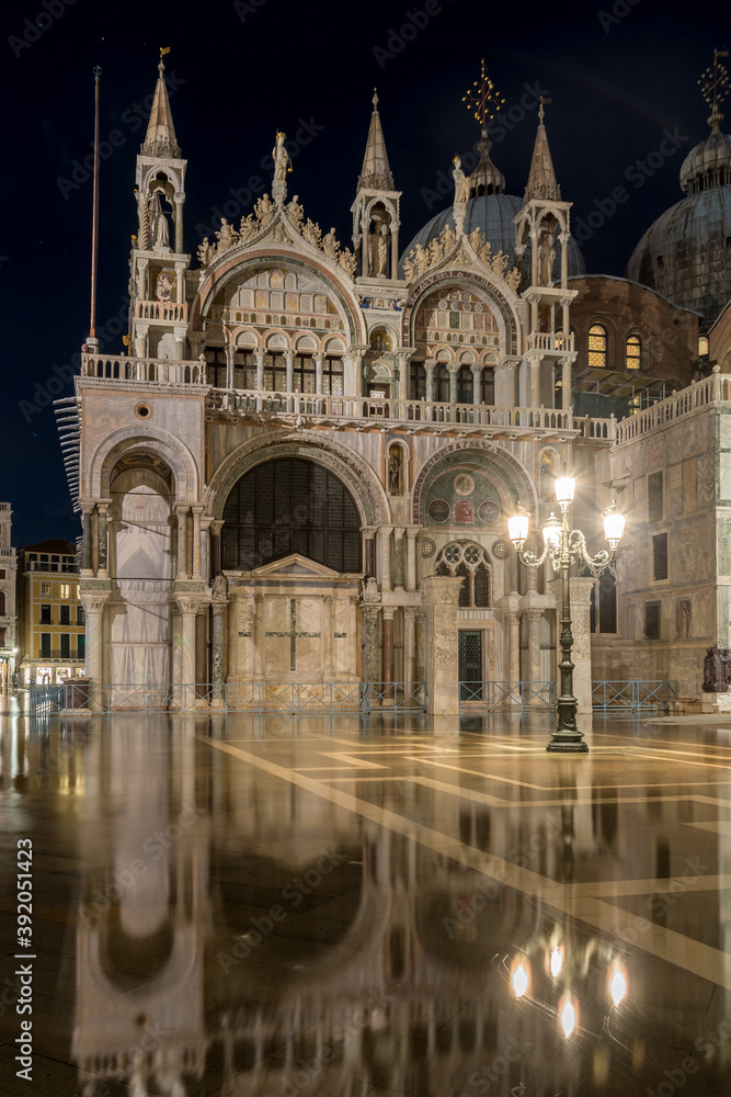 Cattedrale di San Marco (St. Mark Cathedral) by night with acqua alta (high water) on San Marco Square in Venice, Venezia