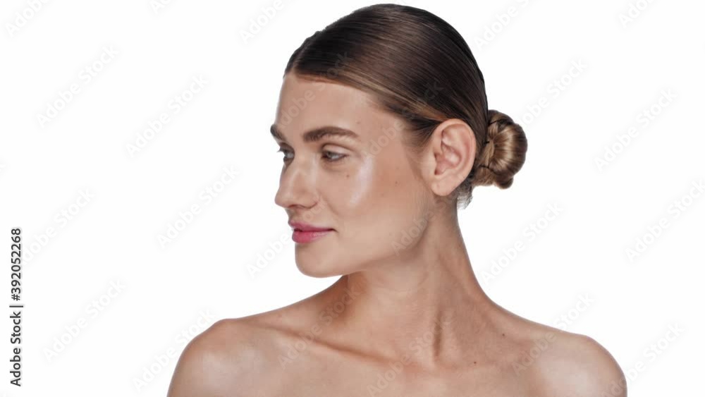 Smiling young adult woman with naked shoulders posing isolated on white Smiling young adult woman with naked shoulders posing isolated on white
