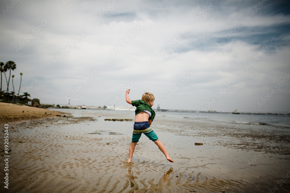 Six Year Old Boy Skipping Rocks in Coronado Bay Six Year Old Boy Skipping Rocks in Coronado Bay