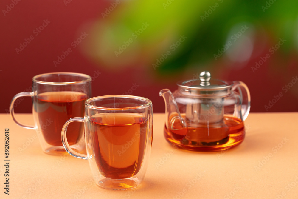 Glass teapot and two glass cups with tea Glass teapot and two glass cups with tea
