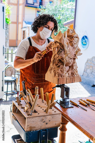 Sculptress with mask carving wooden figure