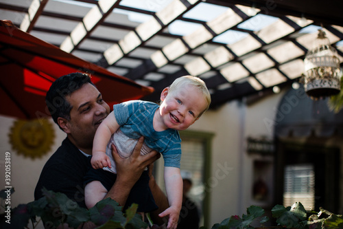 Uncle Holding Nephew in Front Yard in San Diego