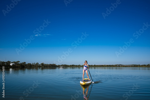 Girl paddleboarding in lake outside of lawrence kansas photo