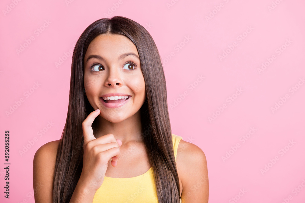 Photo of curious pretty girl look empty space hold finger chin isolated on shine pastel pink color background Photo of curious pretty girl look empty space hold finger chin isolated on shine pastel pink color background