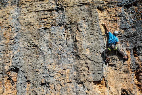 Frontal view of an unrecognizable climber in action photo