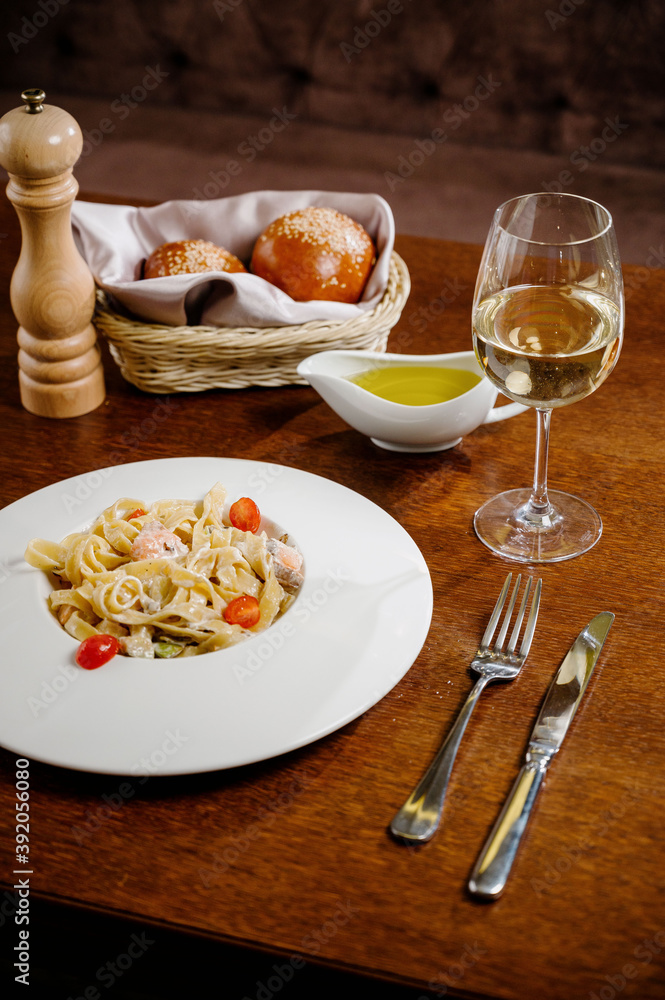 Plate with delicious Chicken Alfredo on table