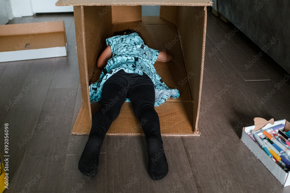 Little girl sleeping in large cardboard box Stock Photo Adobe Stock