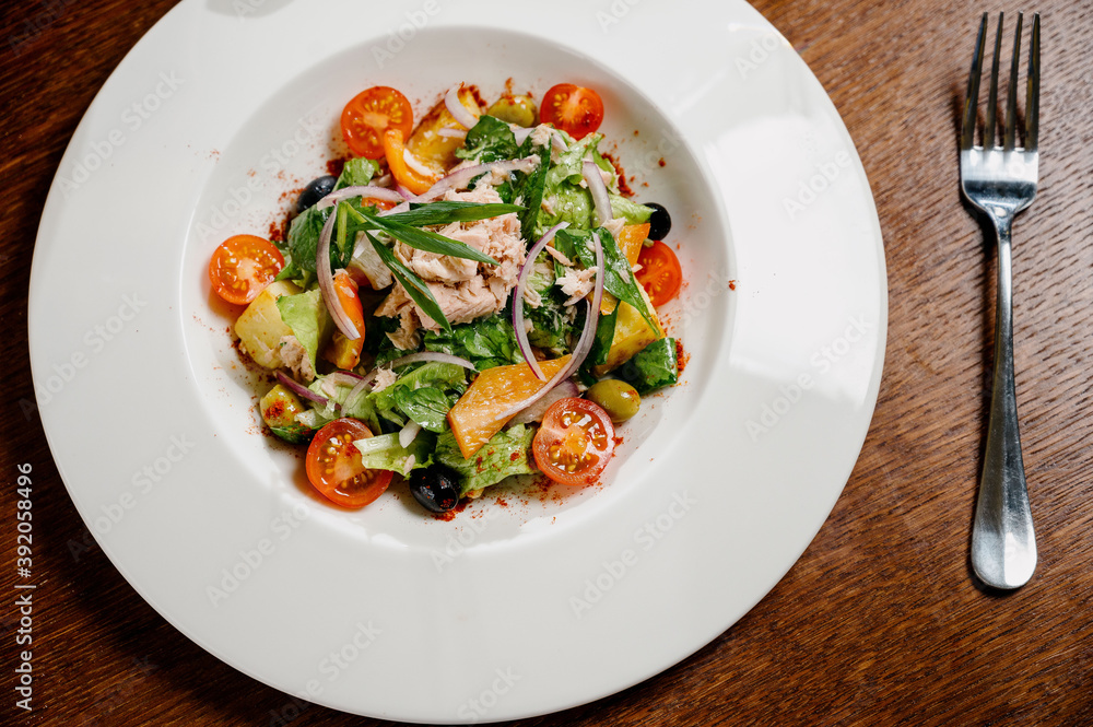 Caesar salad with croutons, quail eggs, cherry tomatoes and grilled chicken in wooden table Caesar salad with croutons, quail eggs, cherry tomatoes and grilled chicken in wooden table