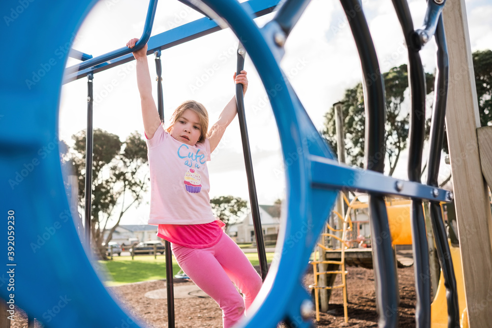 Young girl playing and climbing on playground Young girl playing and climbing on playground