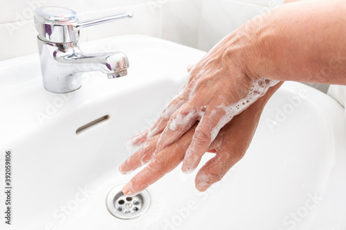 Woman washing her hands and disinfecting them for Coronavirus disease