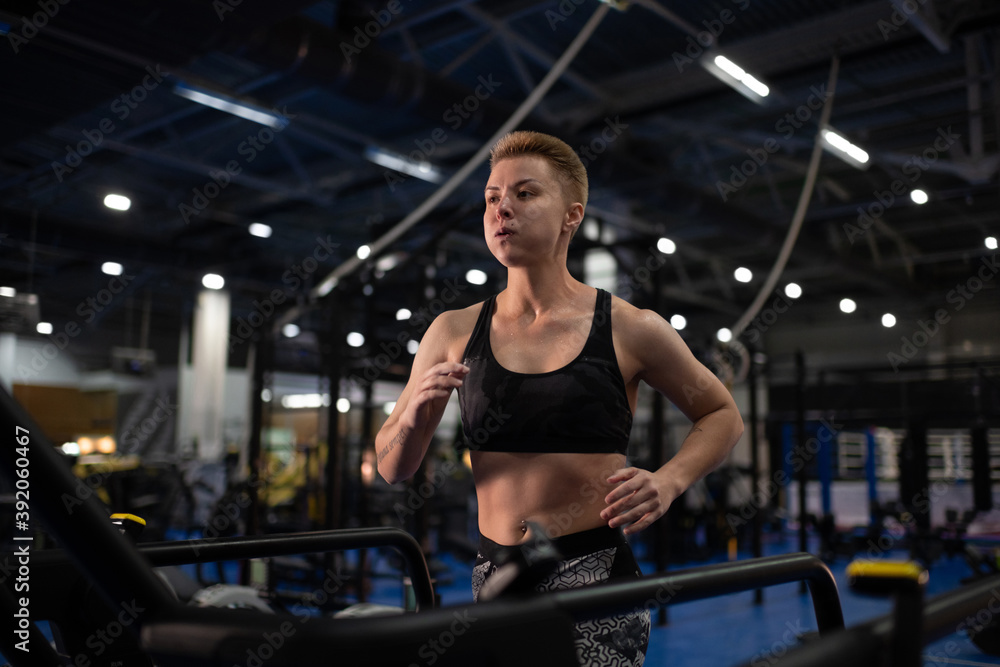 Exhausted sportswoman running on treadmill Exhausted sportswoman running on treadmill
